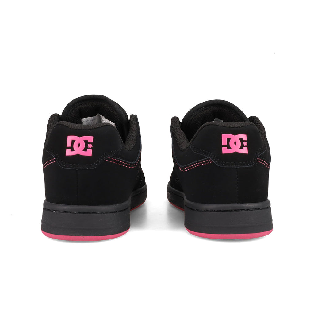 The Women's Manteca 4 Shoes by DC Shoes are black skate sneakers with pink logos on the heels, plus pink midsole and stitching details—ideal for adding a bold touch to your style.