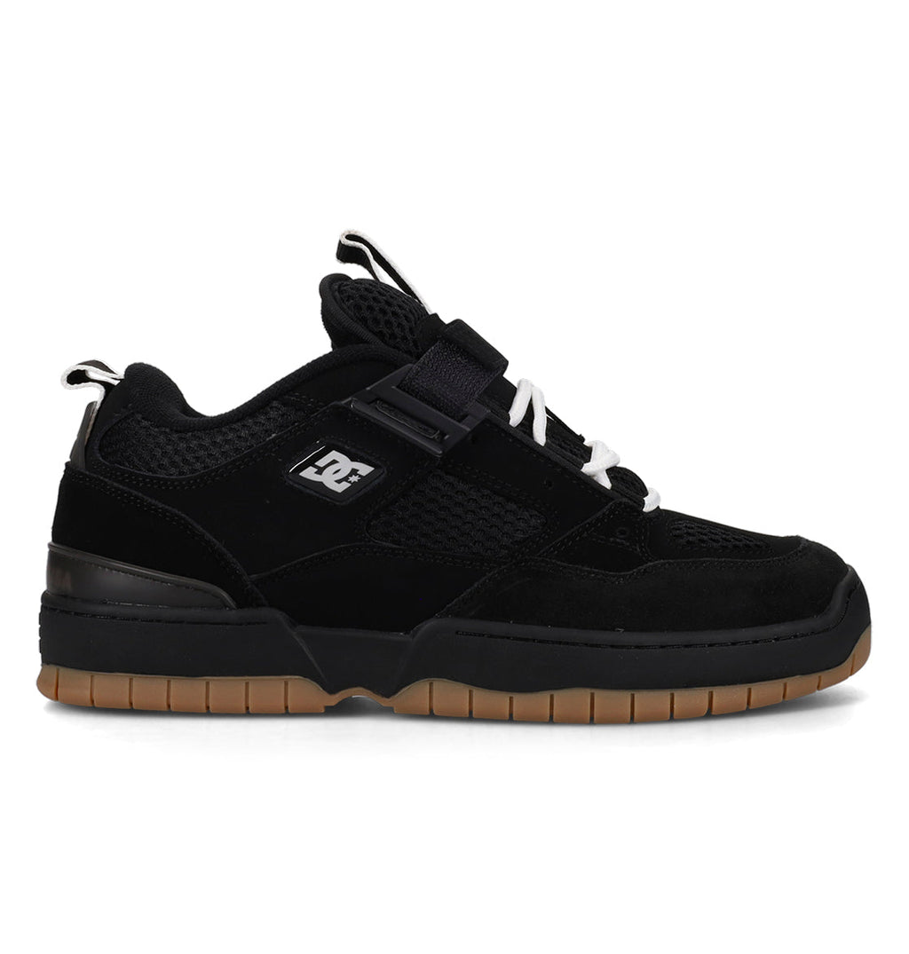 Black sneaker with a visible brand logo on a white background