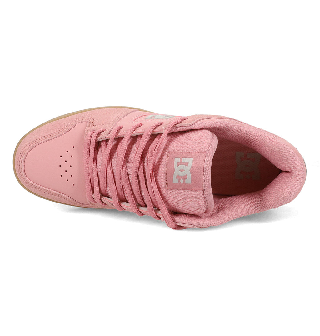A top view of the Women’s Manteca 4 Shoes by DC Shoes in pink, featuring classic laces, a perforated toe area, and a logo on the tongue. The shoe’s lining and the edges of the sole are also visible.