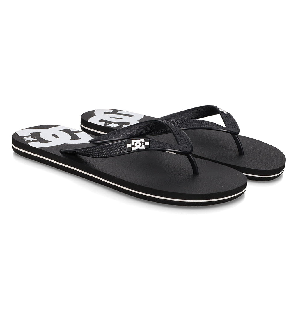 A pair of Men’s Spray Slides from DC Shoes, featuring black straps and a white DC Shoes logo on the footbed, these essential slides are perfect for relaxing after a skate session and are showcased on a clean white background.