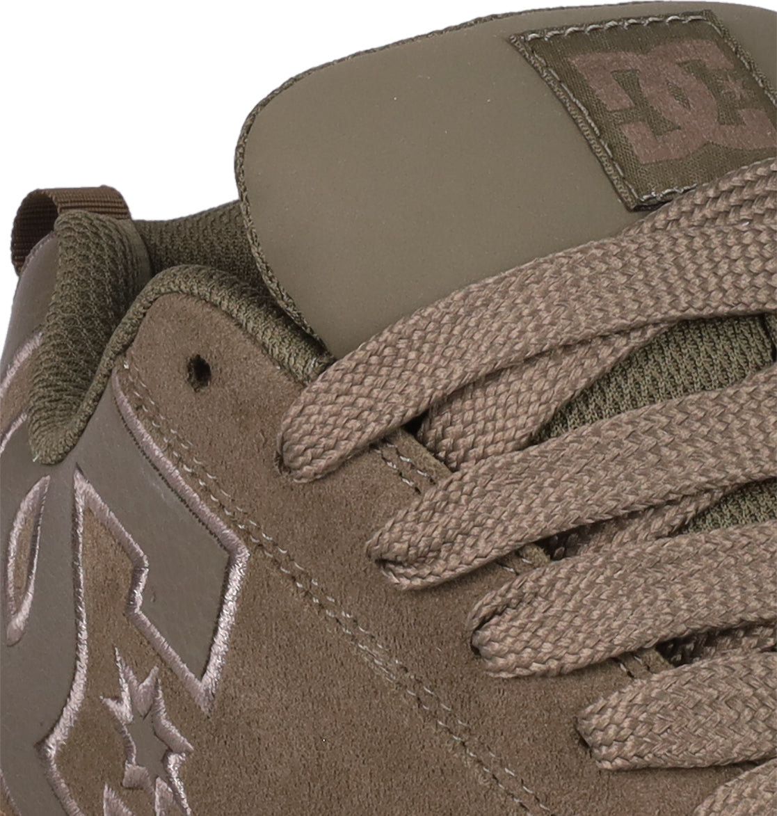 Close-up of the DC Shoes Women's Court Graffik SD sneaker in brown suede, featuring matching laces, stitched logos on the side and tongue, visible eyelets, textured details, and a plush puffy silhouette for a trendy look.