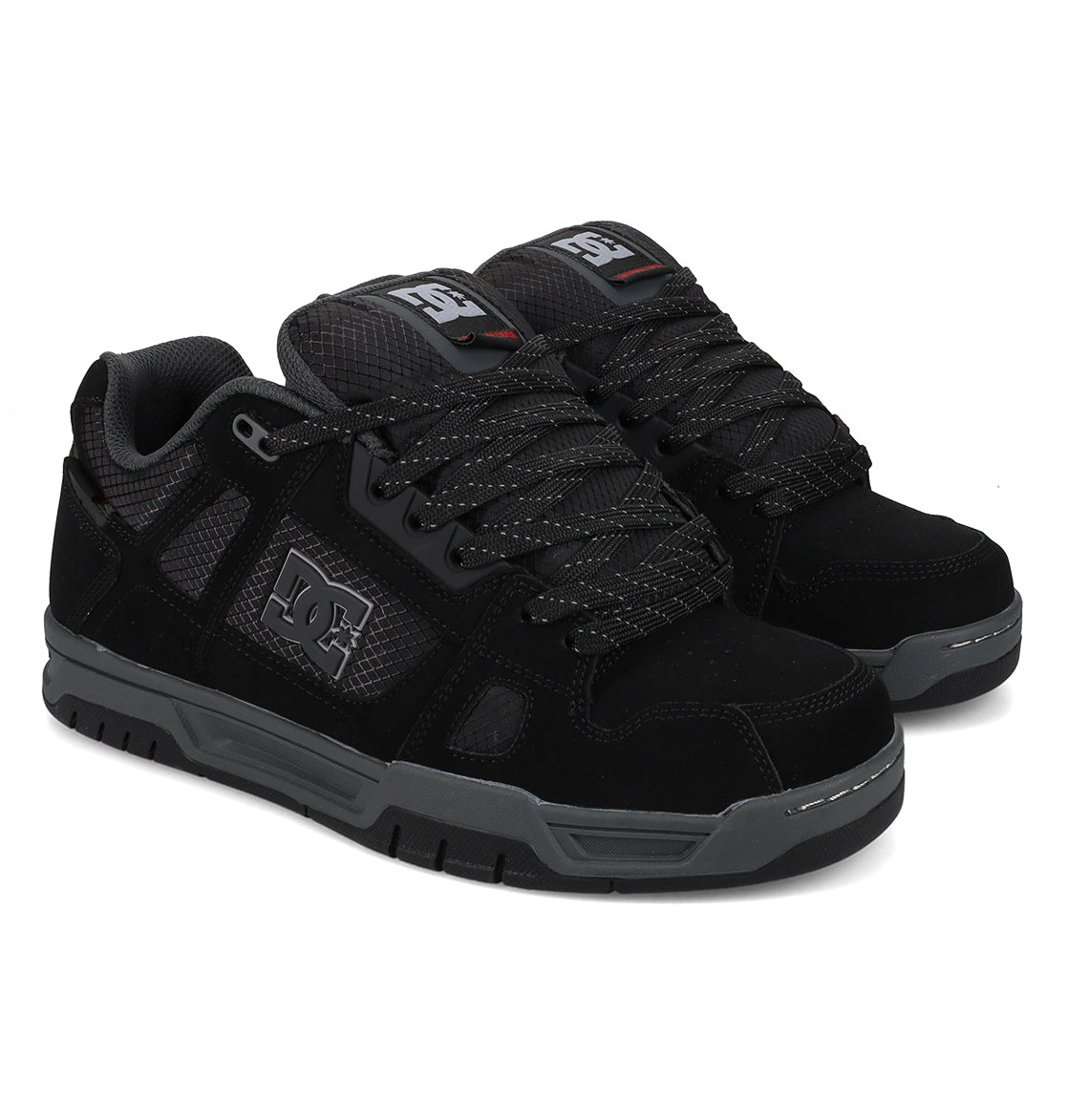 A pair of Men’s Stag Winterized Shoes by DC Shoes in black, designed with gray soles and textured leather panels. These shoes feature the DC Shoes logo on the side, black laces with gray accents, padded tongues, and lightweight cushioning for excellent impact absorption.