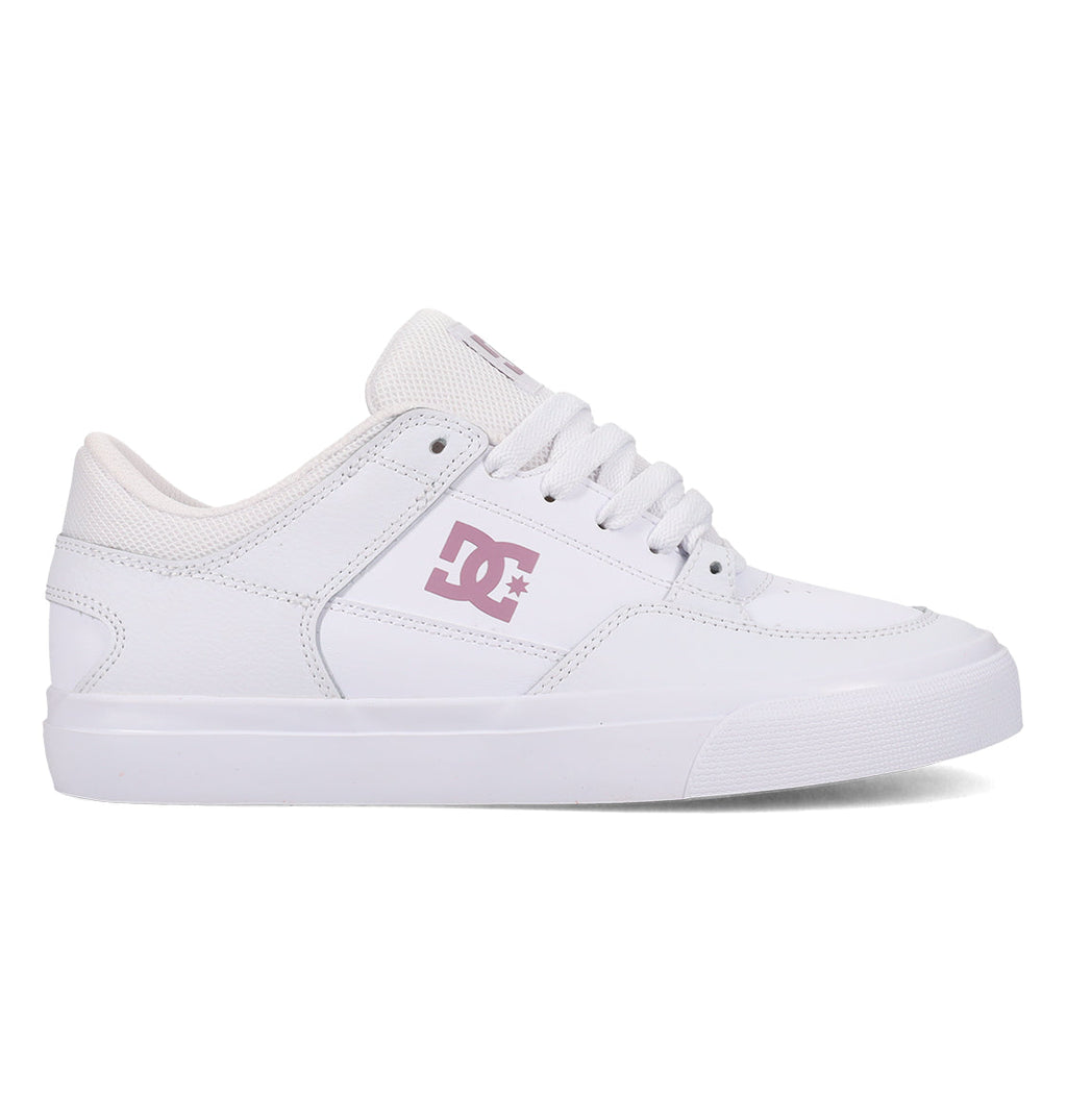 The DC Shoes Women’s Onyx Shoes are white skate shoes with a clean, minimal silhouette, highlighted by a pink DC logo on the side, white laces, and a matching white sole. Pictured in side profile against a plain background, these vulc shoes blend classic style with versatile comfort—ideal for everyday wear.