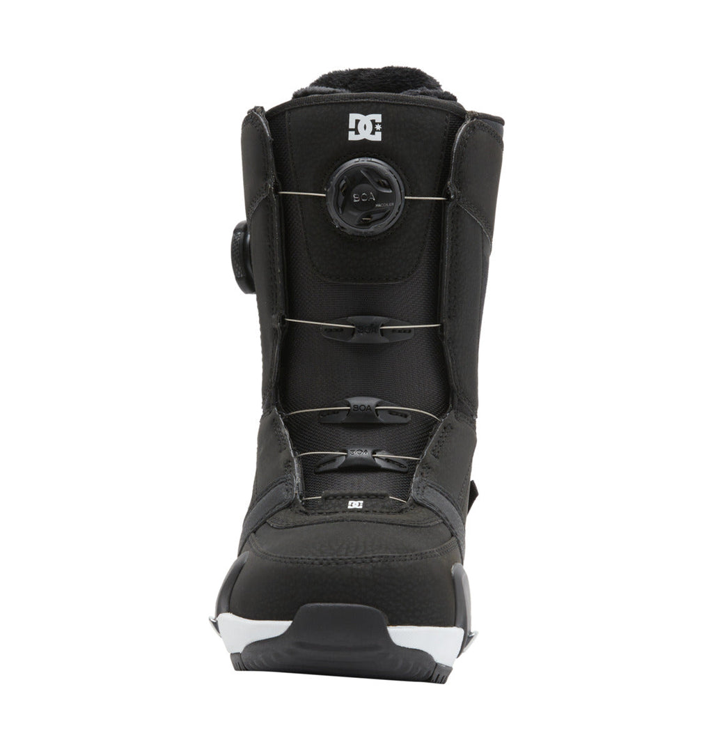 A front-facing image of the DC Shoes Women’s Lotus Step On® Snowboard Boot in black, featuring the Dual Zone BOA Fit System with a round tightening dial on the front, silver laces, and the DC logo near the top, displayed against a white background.