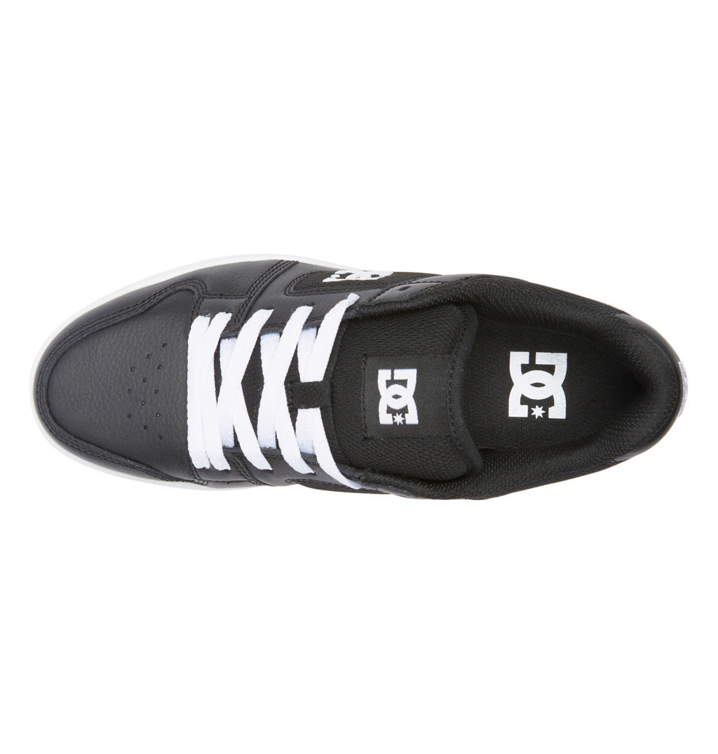 Top view of a black Women’s Manteca 4 Platform Shoe by DC Shoes, featuring white laces and a white DC Shoes logo on the tongue and side. This low-top design includes perforations on the toe area.
