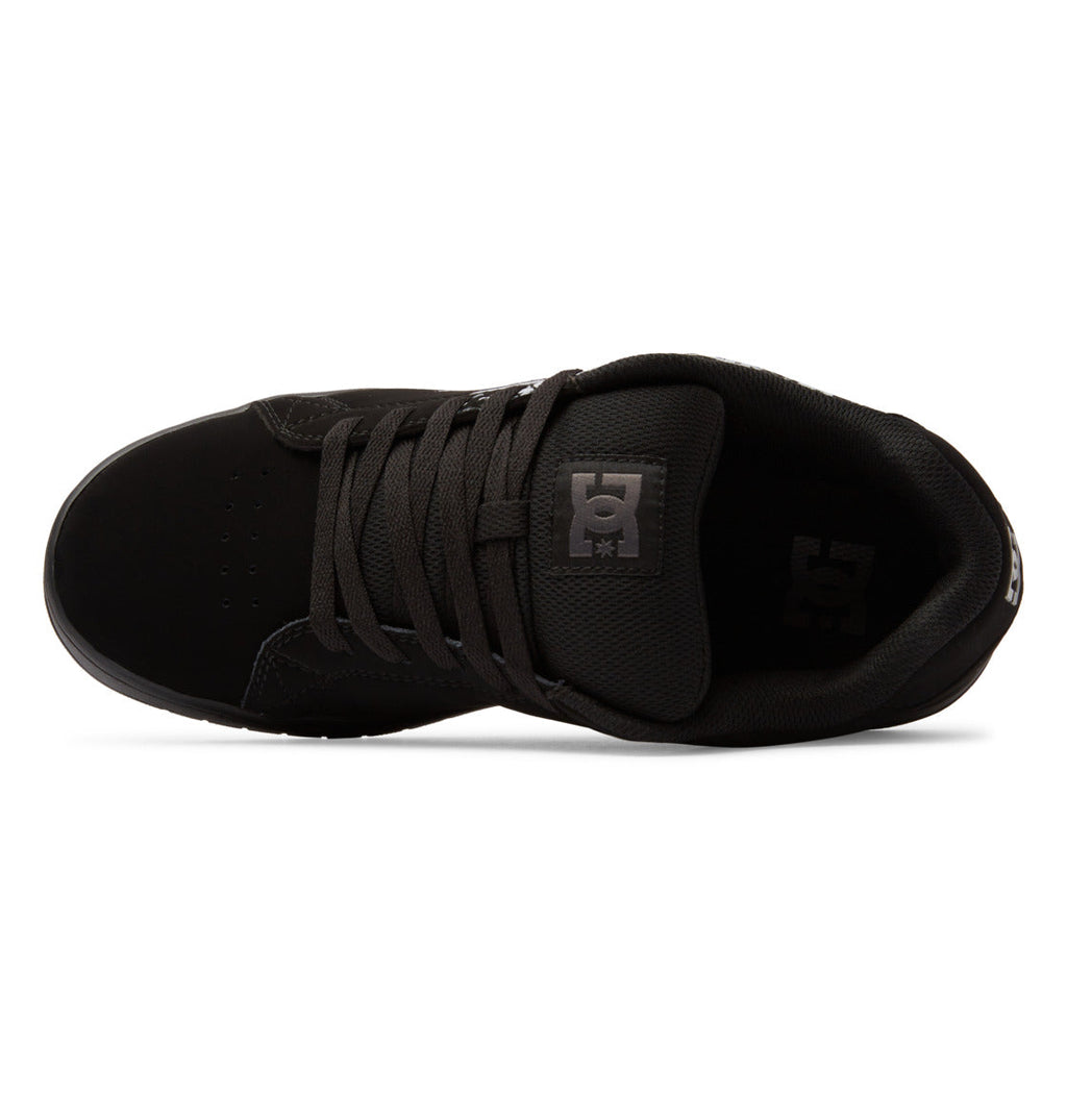 Top view of the Men’s Gaveler Shoes by DC Shoes in black, featuring matching black laces and a DC Shoes logo on the tongue. This sneaker showcases a low-profile silhouette with a rounded toe, crafted from a mix of suede and mesh with durable leather accents for enhanced resilience. Its subtly chunky design blends modern style with lasting substance.