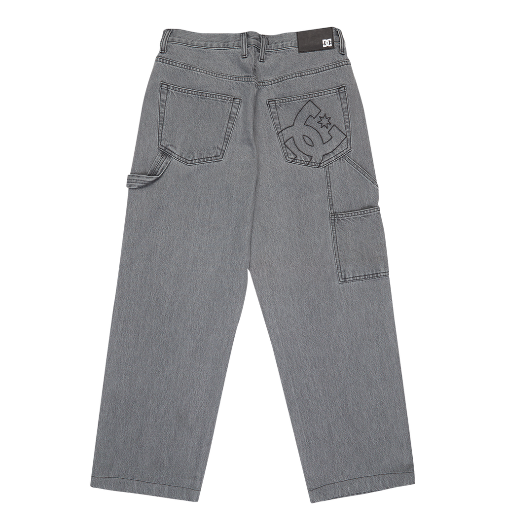 The Men's Baggy Denim Carpenter Pant by DC Shoes features heavyweight denim, a wide-leg fit, multiple pockets, a hammer loop, and a large DC Shoes logo embroidered on the right pocket.